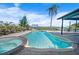 Spacious backyard featuring a pristine pool with an attached jacuzzi and tropical landscaping at 50 Spyglass Aly, Placida, FL 33946