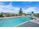 Large, inviting pool showcasing the surrounding landscaping, pool house, and clear blue sky at 50 Spyglass Aly, Placida, FL 33946