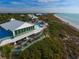 Aerial view of beachside clubhouse and pool area, showing patio, ocean and white sand beach at 5000 Gasparilla Rd # 41B, Boca Grande, FL 33921