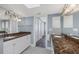 A bathroom with double sinks, marble countertops, a large mirror, and plenty of storage space at 5000 Gasparilla Rd # 41B, Boca Grande, FL 33921