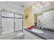 Clean bathroom featuring a tub, white tile surround, and modern fixtures with an ornate mirror at 5000 Gasparilla Rd # 41B, Boca Grande, FL 33921