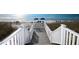 Direct beach access via wooden steps leading to the white sandy beach and ocean at 5000 Gasparilla Rd # 41B, Boca Grande, FL 33921