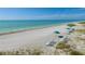 Relax on the white sand beach with crystal-clear water and private beach chairs with umbrellas at 5000 Gasparilla Rd # 41B, Boca Grande, FL 33921