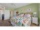 Calm bedroom adorned with coastal decor, soothing green walls, and ample natural light at 5000 Gasparilla Rd # 41B, Boca Grande, FL 33921