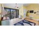 A bedroom featuring a sliding glass door to a balcony, and decorated with a ceiling fan and decorative accessories at 5000 Gasparilla Rd # 41B, Boca Grande, FL 33921