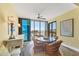 Cozy dining area features a round table, wicker chairs, and panoramic ocean vistas at 5000 Gasparilla Rd # 41B, Boca Grande, FL 33921