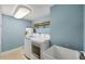 A laundry room with a blue wall, a front-load washer and dryer, and a sink at 5000 Gasparilla Rd # 41B, Boca Grande, FL 33921