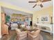Open-concept living space with coastal decor, comfortable seating, and sunlit dining area at 5000 Gasparilla Rd # 41B, Boca Grande, FL 33921