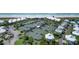 Aerial view of the condo community's tennis courts, parking lot, and white sand beach at 5000 Gasparilla Rd # 41B, Boca Grande, FL 33921