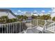 Enjoy the view from this balcony with white railing, palm trees, and seating for relaxation at 5000 Gasparilla Rd # Vh37, Boca Grande, FL 33921