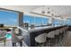 Upscale bar area with coastal views, stylish seating, and elegant pendant lighting for a refined ambiance at 5000 Gasparilla Rd # Vh37, Boca Grande, FL 33921