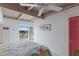 Inviting bedroom with bright decor, light wood ceiling beams, and ocean view access to the outdoor deck at 5000 Gasparilla Rd # Vh37, Boca Grande, FL 33921