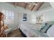 Comfortable bedroom with twin beds, wood floors, and ample natural light, creating a warm and inviting atmosphere at 5000 Gasparilla Rd # Vh37, Boca Grande, FL 33921
