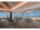 Elegant dining room with ocean views, modern lighting, and stylish seating for a luxurious experience at 5000 Gasparilla Rd # Vh37, Boca Grande, FL 33921