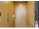 Inside the elevator, wood paneled walls feature buttons, a phone, and a safety rail at 5000 Gasparilla Rd # Vh37, Boca Grande, FL 33921