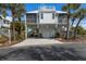 Charming raised beach house with brick driveway, garage, palm trees and rooftop terrace at 5000 Gasparilla Rd # Vh37, Boca Grande, FL 33921