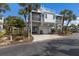 Beautiful elevated home with lush landscaping, garage, and rooftop deck in a tropical setting at 5000 Gasparilla Rd # Vh37, Boca Grande, FL 33921