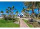 Stunning home exterior surrounded by lush greenery, a brick path, and manicured landscaping at 5000 Gasparilla Rd # Vh37, Boca Grande, FL 33921