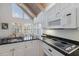 The kitchen boasts granite countertops, white cabinetry, and stainless steel appliances, with a bright dining area nearby at 5000 Gasparilla Rd # Vh37, Boca Grande, FL 33921