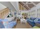 Bright living room with vaulted ceilings, shuttered windows, and comfortable seating at 5000 Gasparilla Rd # Vh37, Boca Grande, FL 33921