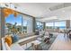 Bright living room with multiple seating areas, large windows offering picturesque beach views, and modern decor at 5000 Gasparilla Rd # Vh37, Boca Grande, FL 33921