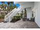 Outdoor patio with seating area and stairs leading to the main level of the home at 5000 Gasparilla Rd # Vh37, Boca Grande, FL 33921