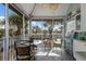 Charming sunroom featuring tiled floors, wicker furniture, ceiling fan and view of the neighborhood at 5000 Gasparilla Rd # Vh37, Boca Grande, FL 33921