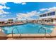 Large swimming pool surrounded by lounge chairs and umbrellas, perfect for relaxing in the sun at 5000 Gasparilla Rd # Vh37, Boca Grande, FL 33921