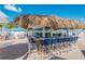 Outdoor tiki bar with blue stools and ocean view, perfect for enjoying cocktails in a relaxed atmosphere at 5000 Gasparilla Rd # Vh37, Boca Grande, FL 33921