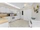 Efficient kitchen with white cabinetry, tile floors, and bright lighting at 544 Foxwood Blvd, Englewood, FL 34223