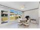 Bright sunroom features large windows overlooking the backyard and tile flooring at 544 Foxwood Blvd, Englewood, FL 34223