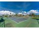 The tennis court is ready for a match on a beautiful day with blue skies and fluffy clouds at 544 Foxwood Blvd, Englewood, FL 34223