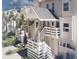 Close up of white townhome featuring private entrances, manicured landscaping, and coastal charm at 5800 Gulf Shores Dr # 33, Boca Grande, FL 33921