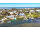 Aerial view of waterfront homes with private docks and boat lifts on a beautiful coastal inlet at 6035 Manasota Key Rd, Englewood, FL 34223