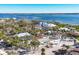 Aerial view of a house, surrounded by lush trees, offering stunning water views at 6035 Manasota Key Rd, Englewood, FL 34223