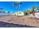 Spacious backyard with green grass and a white fence at 6035 Manasota Key Rd, Englewood, FL 34223