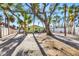 Backyard with palm trees in the background, and stepping stones to the back door at 6035 Manasota Key Rd, Englewood, FL 34223