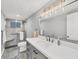 Modern bathroom featuring a spacious vanity, sleek fixtures, and a well-lit mirror at 6035 Manasota Key Rd, Englewood, FL 34223