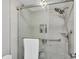 Modern bathroom showcasing a walk-in shower with glass doors and grab bars at 6035 Manasota Key Rd, Englewood, FL 34223