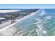 Gorgeous aerial view of the shoreline with white sandy beaches and crystal-clear ocean waves at 6035 Manasota Key Rd, Englewood, FL 34223