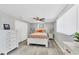 Bright bedroom with hardwood floors, windows with blinds, and stylish furniture at 6035 Manasota Key Rd, Englewood, FL 34223