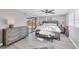 Bright bedroom featuring a comfortable bed, stylish decor, and sliding glass doors at 6035 Manasota Key Rd, Englewood, FL 34223