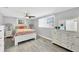 Bright bedroom with hardwood floors, windows with blinds, and stylish furniture at 6035 Manasota Key Rd, Englewood, FL 34223