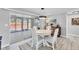 Bright dining area with a round table and seating for four, seamlessly connected to an outdoor living space at 6035 Manasota Key Rd, Englewood, FL 34223