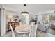 Bright and inviting dining area with a wood table adjacent to the living room at 6035 Manasota Key Rd, Englewood, FL 34223