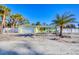Charming coastal home featuring a paved driveway and lush tropical landscaping at 6035 Manasota Key Rd, Englewood, FL 34223