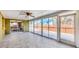Bright Florida room with tile flooring, ceiling fan, and sliding glass doors to outside at 6035 Manasota Key Rd, Englewood, FL 34223