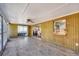 Enclosed sunroom with neutral tile, paneled walls, and access to dining area at 6035 Manasota Key Rd, Englewood, FL 34223