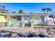 Charming single-story home with white trim, a quaint front entrance, and a well-maintained yard at 6035 Manasota Key Rd, Englewood, FL 34223