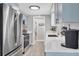 Modern kitchen features stainless steel appliances, white quartz countertops, and light blue cabinetry at 6035 Manasota Key Rd, Englewood, FL 34223
